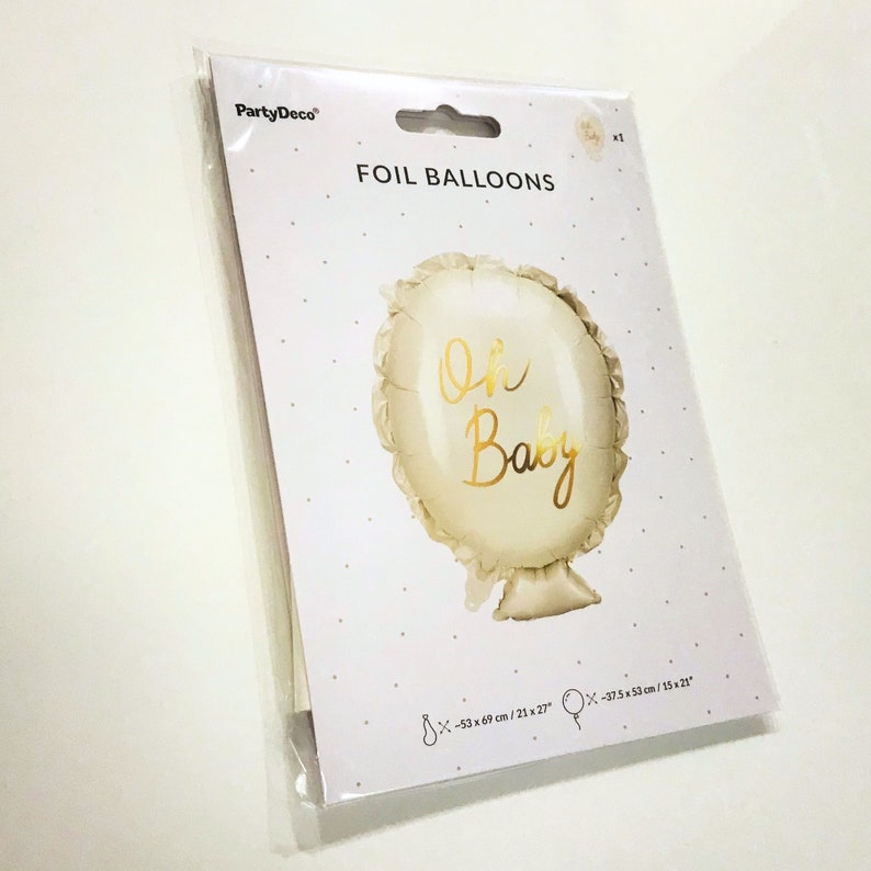 May include: A white foil balloon with a gold 'Oh Baby' inscription. The balloon is 21 inches by 27 inches and is packaged in a clear plastic bag.