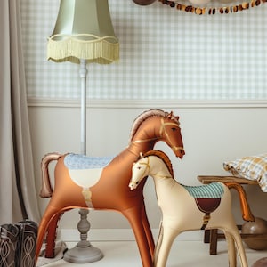 Standing brown horse foil balloon displayed with rustic western party decorations and balloons