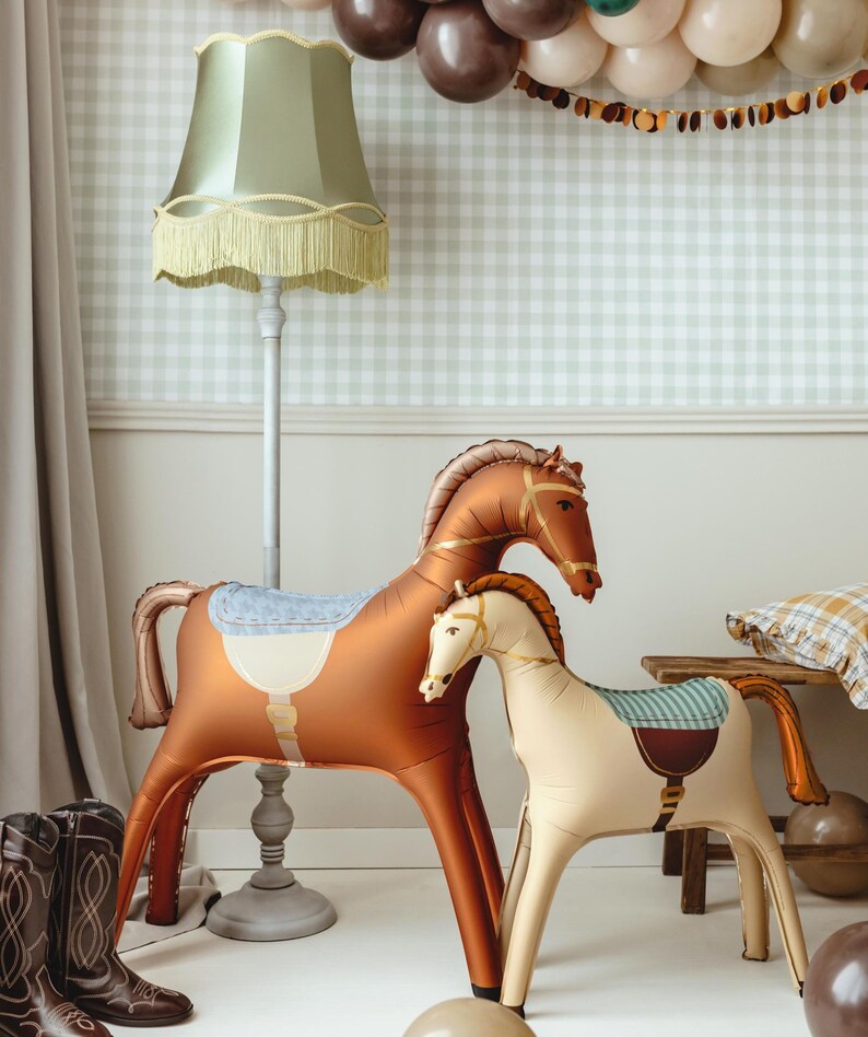 Standing brown horse foil balloon displayed with rustic western party decorations and balloons