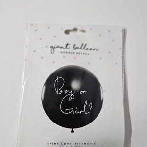 May include: Black gender reveal balloon with white text that says "Boy or Girl?" and pink confetti inside.  Giant balloon, 1 piece.