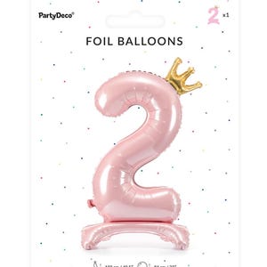May include: Two pink foil balloons shaped like the number 2 with a gold crown on top. The balloons are 40.5 inches tall and 33 inches wide.