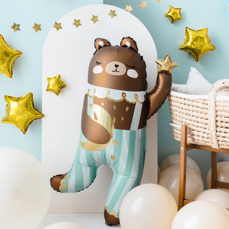 Teddy bear balloon styled with pastel blue and gold decorations for baby shower, newborn party or first birthday