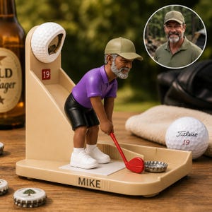 May include: A beige bottle opener featuring a figurine of a golfer with a gray beard, wearing a purple polo shirt, black shorts, and a beige cap. The base is labeled MIKE and includes a red golf club, a white golf ball, and a number 19 square.