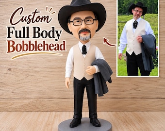 May include: A custom full body bobblehead figure wearing a black cowboy hat, glasses, a white shirt, a beige vest, a black bolo tie, and black trousers, holding a grey jacket. The figure stands on a circular grey base with text reading Custom Full Body Bobblehead.