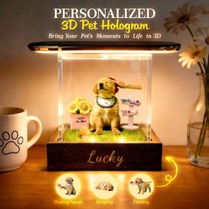 May include: A personalized 3D pet hologram display. The display features a golden retriever puppy figurine inside a clear acrylic case, with the word "Lucky" on the wooden base. The text "PERSONALIZED 3D Pet Hologram" is at the top.