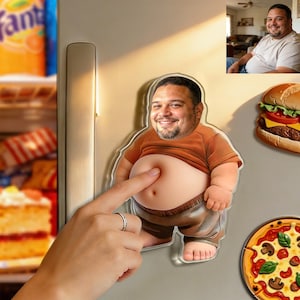 May include: A refrigerator magnet shaped like a man with a large belly, wearing a brown shirt and pants. A finger is touching the belly. Other magnets include a burger and pizza.