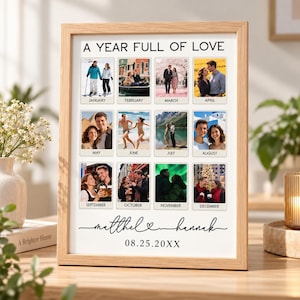 May include: A framed photo collage titled A YEAR FULL OF LOVE featuring twelve individual photographs labeled by month from January to December. Below the photos, the names Matthew and Hannah are written in script with a date 08.25.20XX.