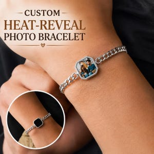 May include: A silver-toned chain bracelet featuring an octagonal pendant that displays a color photograph of a family. The text CUSTOM HEAT-REVEAL PHOTO BRACELET is visible above. An inset shows the same bracelet with a solid black pendant surface.