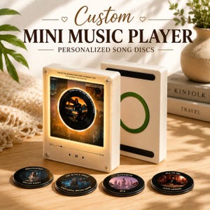 May include: A white square music player with a central circular display showing album art and a glowing ring. Four small black circular discs with printed song titles and artist names are arranged in front. Text reads Custom Mini Music Player.