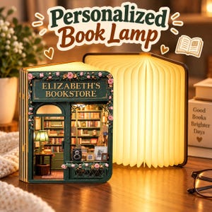 May include: A book-shaped lamp featuring a miniature bookstore diorama titled Elizabeth's Bookstore on the front cover, decorated with pink roses. The lamp emits a warm glow from its accordion-style pages, creating a soft, illuminated display.