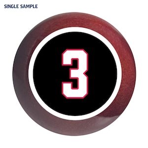 May include: A red and black round ball with the number 3 in white with a red outline.