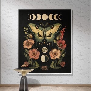 May include: A black canvas print featuring a green and yellow butterfly surrounded by pink flowers and a crescent moon design. The print has a dark background with a white crescent moon design.