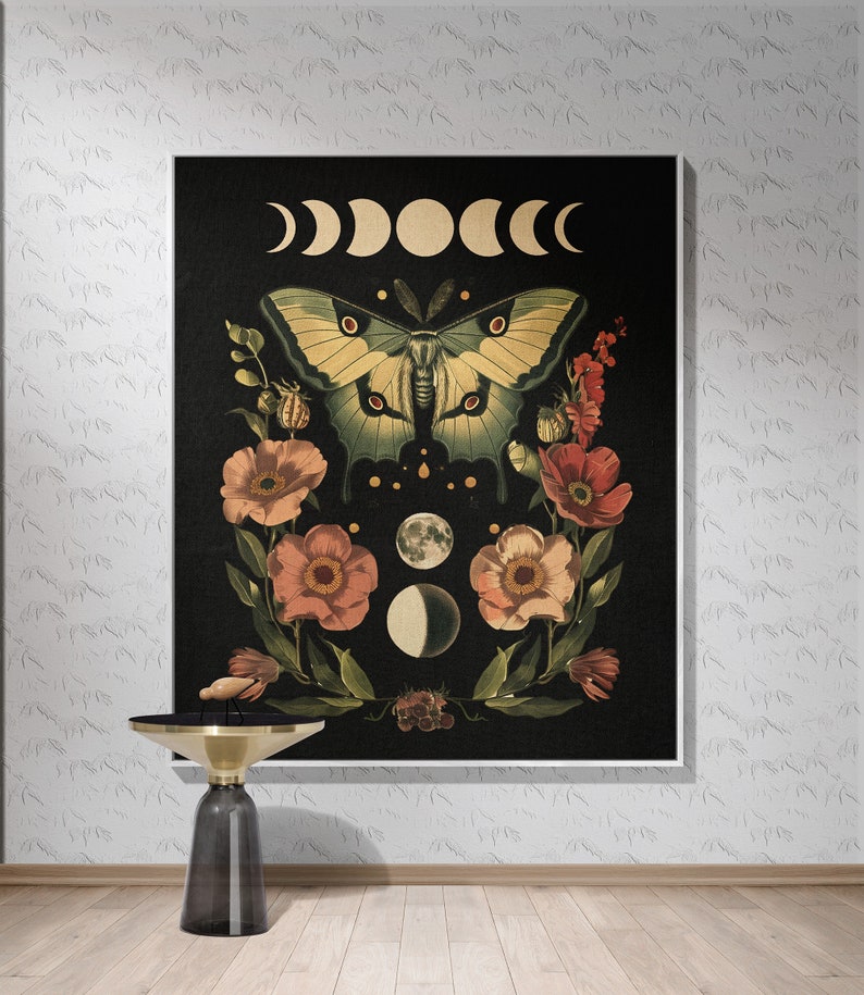 May include: A black canvas print featuring a green and yellow butterfly surrounded by pink flowers and a crescent moon design. The print has a dark background with a white crescent moon design.