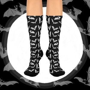 May include: A pair of black socks with a white bat pattern. The socks are knee-high and have a comfortable fit.