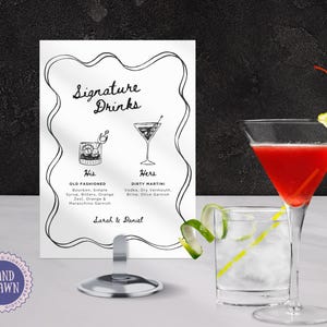 May include: A black and white printable sign with the text "Signature Drinks" and illustrations of two cocktails. The text below the illustrations reads "His Old Fashioned Bourbon, Simple Syrup, Bitters, Orange Zest, Orange & Maraschino Garnish" and "Hers Dirty Martini Vodka, Dry Vermouth, Brine, Olive Garnish". The sign also includes the text "Sarah & Daniel".