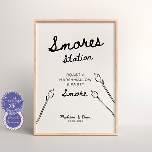 May include: A printable sign with a wooden frame that says "S'mores Station" in black cursive font. It also says "Roast a marshmallow & party S'more" and has a drawing of three marshmallows on sticks. The sign is for Madison & Evan and the date 06.07.2026.