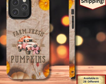May include: A phone case featuring a vintage pink truck carrying pumpkins, with the text "FARM FRESH PUMPKINS." The design includes orange pumpkins and floral accents on a beige background. The case has a glossy finish.
