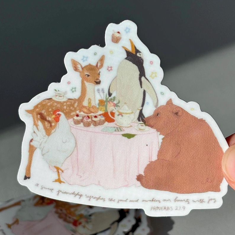 May include: A whimsical sticker featuring a tea party scene with a deer, penguin, bear, and chicken around a pink table. The sticker includes the text "a sweet friendship refreshes the soul and awakens our hearts with joy" and "PROVERBS 27:9".
