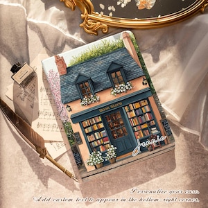 May include: A colorful illustration of a bookstore with a blue and gray roof, a sign that reads "Book Store", and a window display of books. The illustration is on a phone case.