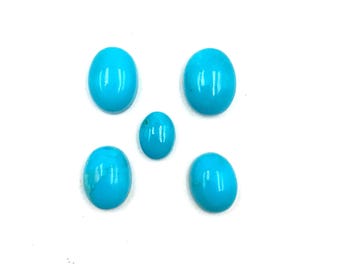 May include: Five polished, oval-shaped turquoise gemstones arranged on a white background. The stones vary slightly in size, with a vibrant, light blue color and a smooth, reflective surface. Ideal for jewelry making or collecting.