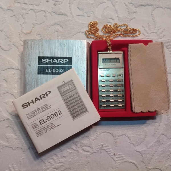 Stylish Vintage Pocket Calculator - Sharp EL-8062 with fob and original packaging with calculator case, chain fob, and original packaging