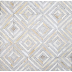May include: A square rug featuring a geometric pattern of interlocking diamonds. The design is composed of thin, rectangular strips of hide in alternating shades of light grey, cream, and soft beige, creating a repeating grid of concentric diamond shapes.