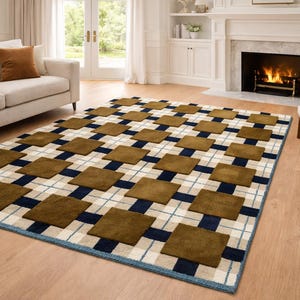 May include: A rectangular area rug with a geometric pattern. The rug features alternating squares of brown and navy blue, set against a cream and light blue plaid background. The rug is placed on a hardwood floor.