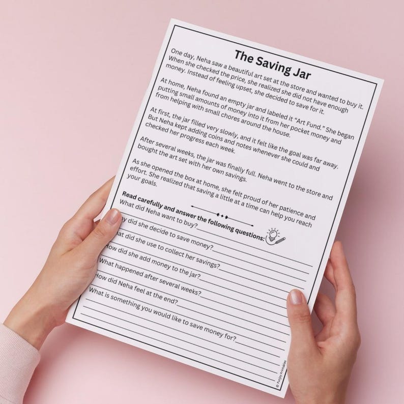 May include: A white paper titled "The Saving Jar" is held by hands. The text describes a story about saving money to buy an art set. The paper includes questions about the story.