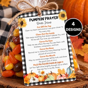 May include: A clear plastic bag filled with orange, yellow, and brown candies, attached to a rectangular tag with a black and white buffalo check border. The tag features sunflowers, pumpkins, and the text Pumpkin Prayer with religious verses.