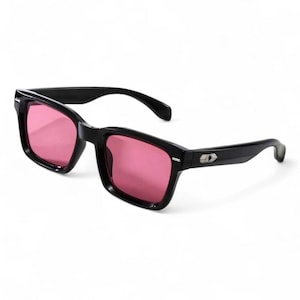 May include: Black-framed sunglasses with pink lenses. The sunglasses have a rectangular shape and a small silver emblem on the temples. The arms curve slightly for a comfortable fit. The lenses are a vibrant pink color.