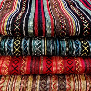 May include: Close-up of stacked fabric with colorful striped patterns. The textiles feature a variety of colors, including red, black, brown, blue, and yellow. The designs incorporate geometric and tribal-inspired motifs, creating a visually rich and textured appearance.