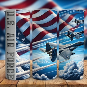 May include: A sublimation tumbler design featuring a red, white, and blue American flag with fighter jets flying through the clouds. The text "U.S. AIR FORCE" is printed on the side of the tumbler.