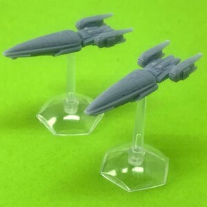 May include: Two gray miniature spaceships on clear plastic stands. The spaceships are sleek and futuristic in design.