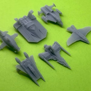 May include: Six gray plastic model spaceships of different designs.