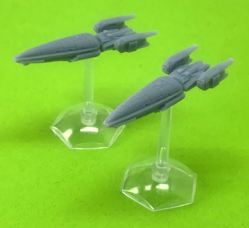 May include: Two gray miniature spaceships on clear plastic stands. The spaceships are sleek and futuristic in design.