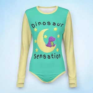 May include: A long-sleeved bodysuit with a teal front and yellow sleeves. The front features the text "Dinosaur Sensation" with a purple dinosaur on a yellow crescent moon, surrounded by yellow stars.