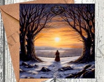May include: A greeting card featuring a winter landscape with a person walking towards a sunset. The artwork is framed by bare trees, with a golden sun setting in the distance. The card is inside a brown envelope.