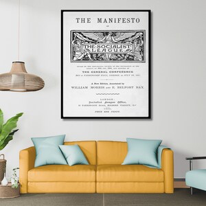 May include: Black and white print of a vintage poster for "The Manifesto of The Socialist League." The poster features a winged figure with the text "The Socialist League" in a banner. The poster also includes the text "A New Edition, Annotated by William Morris and E. Belfort Bax." and "Price One Penny."