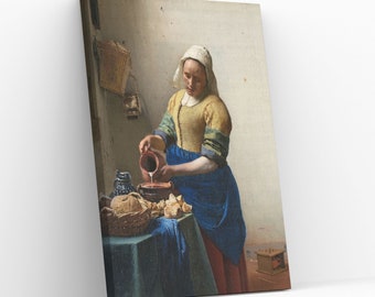 May include: A woman in a blue and yellow dress pours milk from a brown pitcher into a bowl on a table with a basket of bread. The scene is set in a kitchen with a white wall and a basket hanging on the wall.