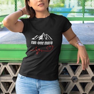 May include: Black t-shirt with a white mountain graphic and the text "run one more" with a red heart and a heartbeat line.