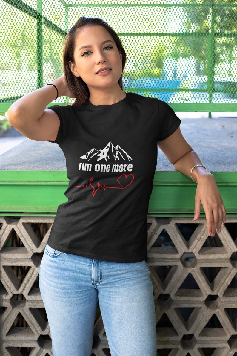 May include: Black t-shirt with a white mountain graphic and the text "run one more" with a red heart and a heartbeat line.