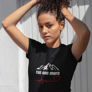 May include: Black t-shirt with a white mountain graphic and the text "run one more" with a red heart and heartbeat graphic.