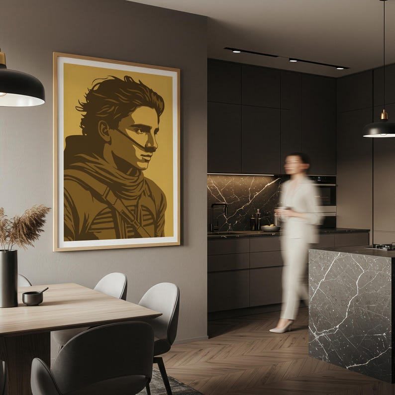 May include: A framed art print featuring a stylized portrait of a person in shades of brown and gold. The artwork is displayed on a wall in a modern kitchen setting. The print has a light wood frame and is a striking piece of wall decor.