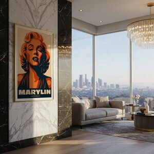 May include: A framed art print featuring a stylized portrait of Marilyn Monroe. The artwork has a gold frame and a color palette of orange, navy, and beige. The print is displayed in a modern living room with a city view.