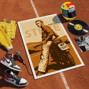May include: An artistic arrangement featuring a poster of Steve McQueen on a motorcycle, a yellow jacket, a racing helmet, a vinyl record, a pair of sneakers, and a microphone. The poster has the name "McQueen" on it.