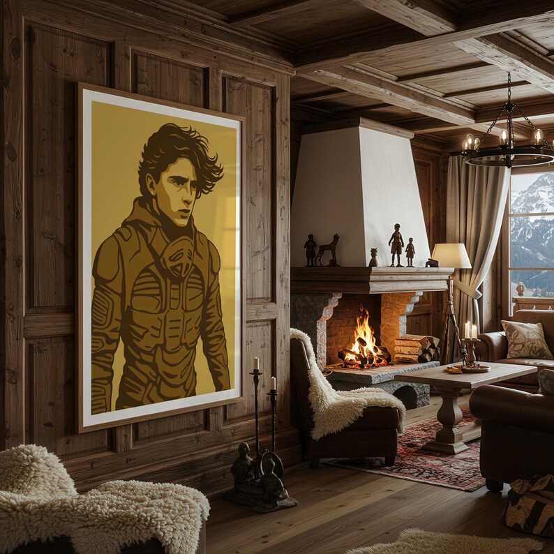 May include: A framed poster featuring a stylized illustration of a person in a brown outfit. The artwork is set against a gold background and hangs on a wood-paneled wall in a cozy living room with a fireplace and mountain view.
