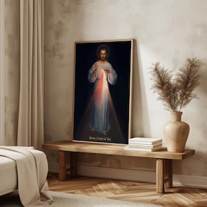 May include: A framed print of a religious figure with a halo, wearing a white robe, and with light emanating from the chest area. The text "Jesus, I trust in You" is at the bottom. The print is displayed on a wooden bench.