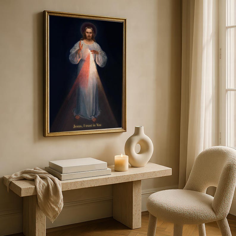 May include: A framed religious artwork depicts a figure in white robes with a halo, radiating light. The text "Jesus, I trust in You" is at the bottom. The artwork hangs above a stone bench with a candle, vase, and a stack of boxes.