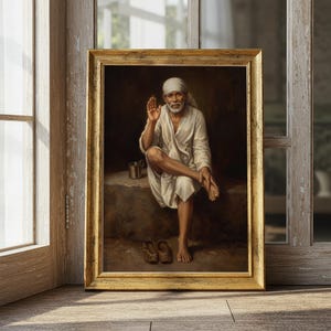 May include: A framed portrait of a spiritual figure in a white robe and head covering, seated with one leg crossed. The artwork features a gold frame and is displayed near a wooden window.