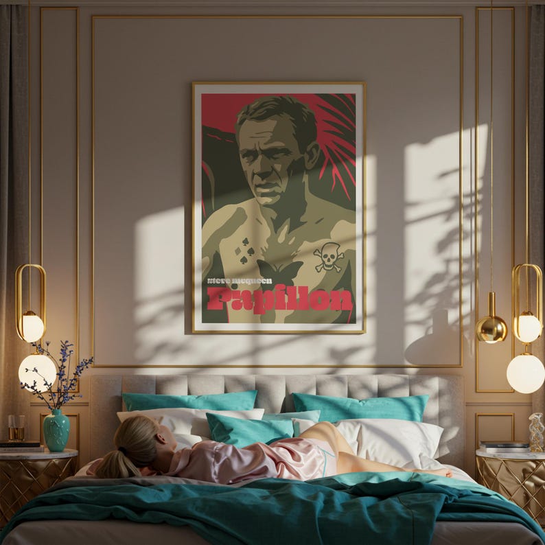 May include: A framed poster featuring a stylized image of a man with tattoos, including a butterfly and skull. The poster has the word "Papillon" in red. The poster is hanging above a bed with teal and white pillows and a teal blanket. A person is lying on the bed.
